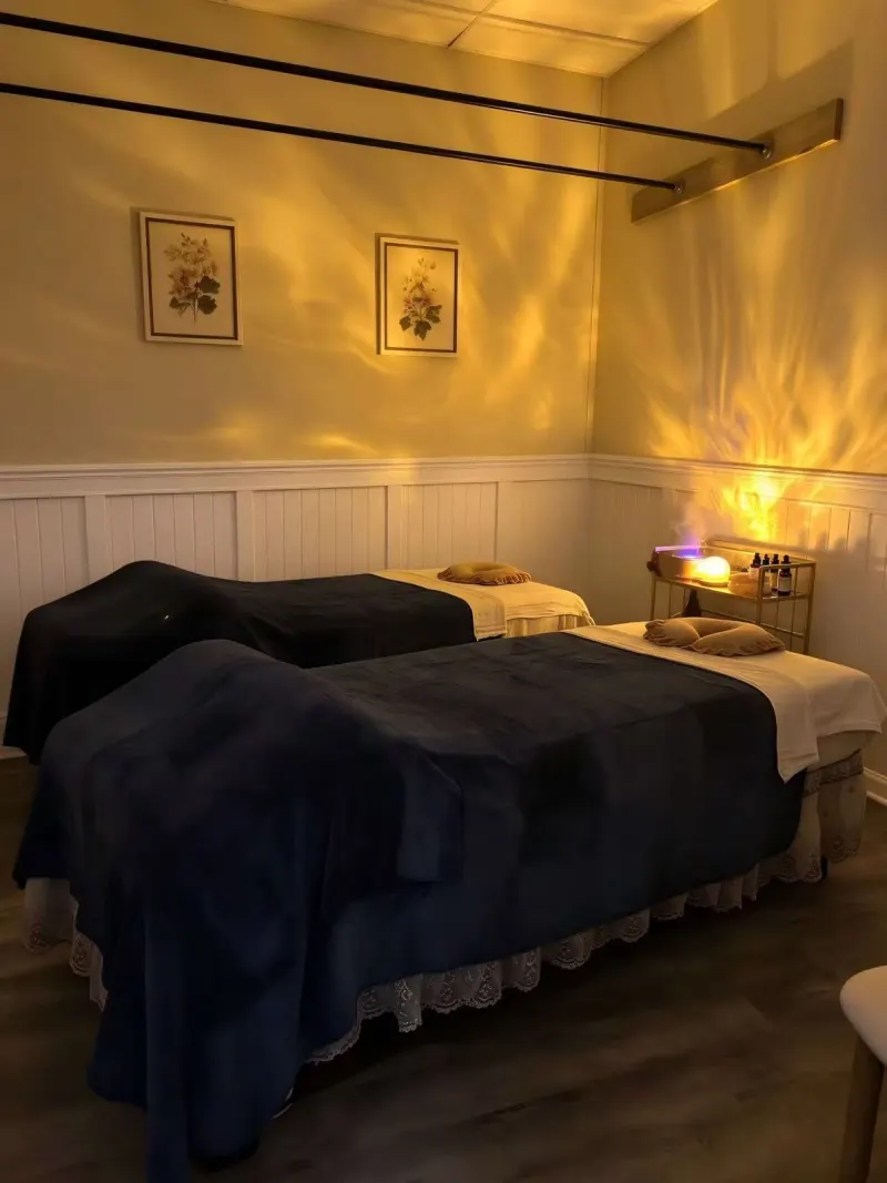 Warmly lit private couples massage room